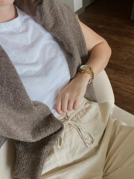 Neutral taupe knit sweater and cream trousers, an old money capsule wardrobe look